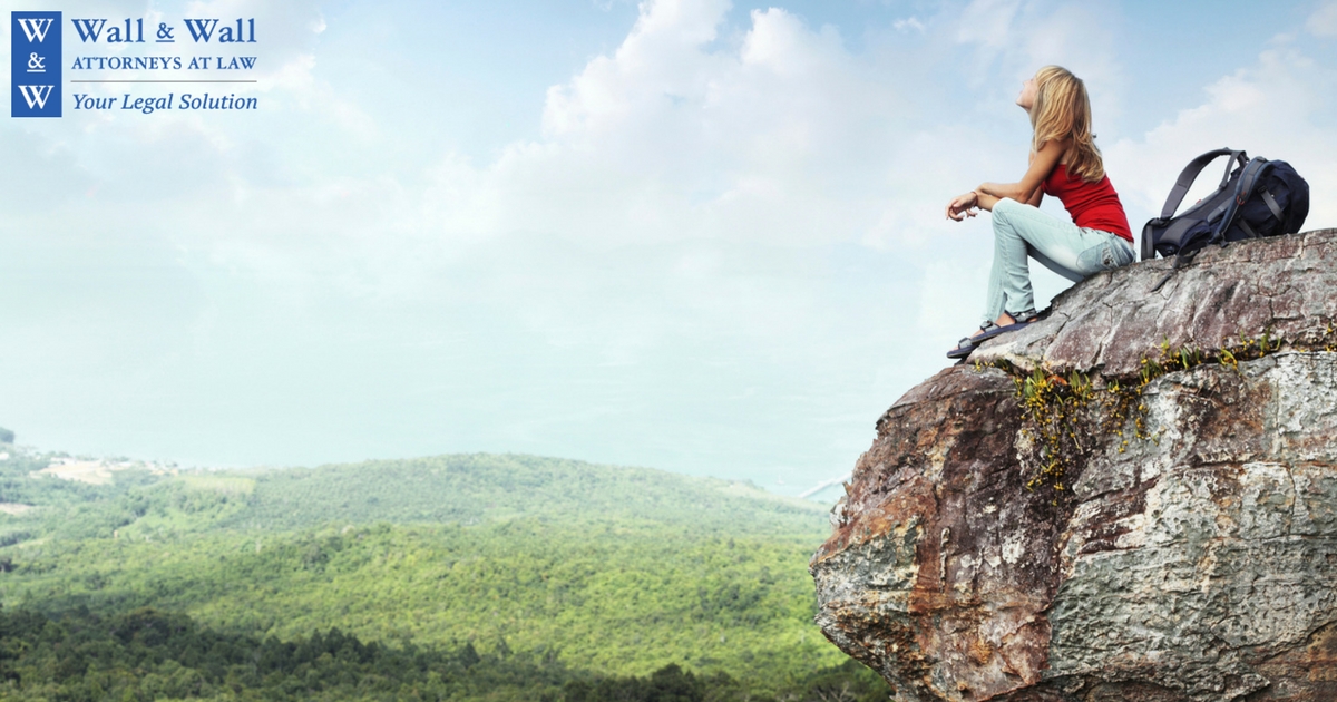 Woman sitting on a rock - 4 Solutions For When You Feel Down After a Divorce