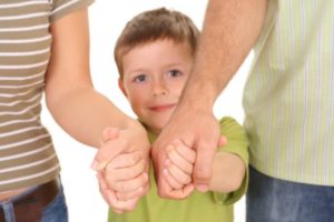 Child Holding Hands With Mom and Dad