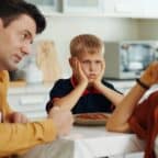 Parent Reflecting on Child Custody Decisions in Utah Parent sitting with a child during an emotional moment while considering Utah custody decisions.