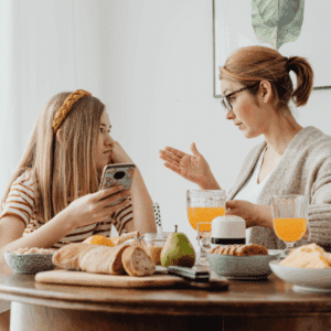 Parents having a calm discussion about resolving custody issues without court conflict.