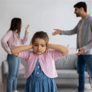 Stressed parent reviewing documents and thinking about a child custody dispute.